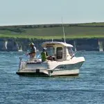 Couple fishing from a boat in Sandbanks