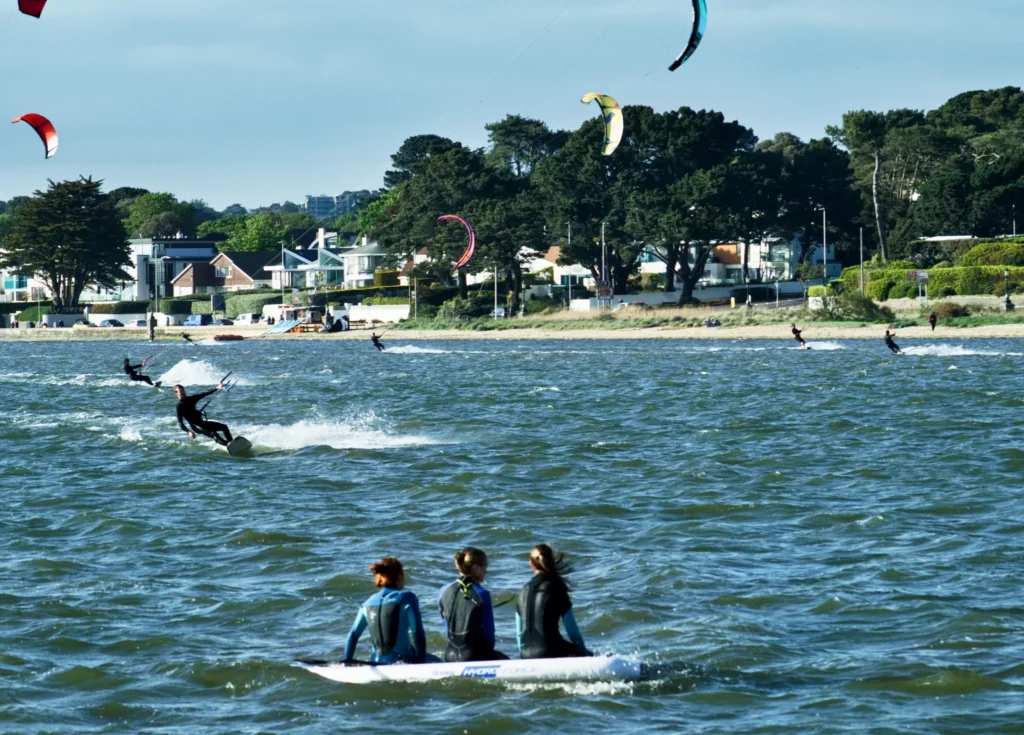 Three girls sat on a paddleboard